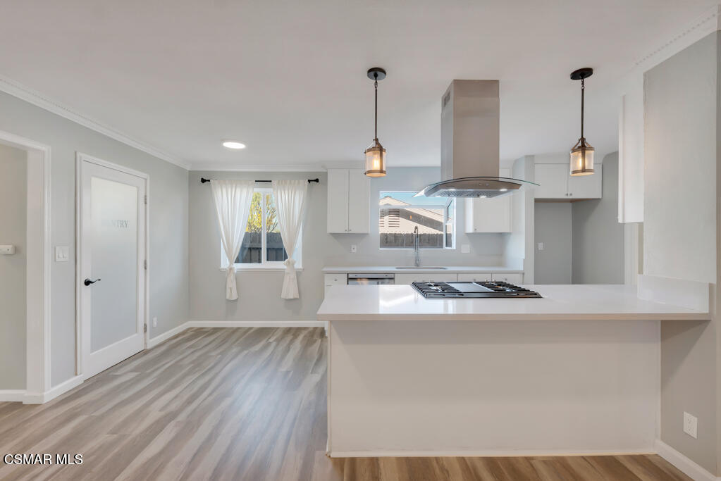 896 Moffatt Circle Simi Valley, CA 93065 - Photo 21 of 50 a kitchen with stainless steel appliances granite countertop a sink a stove a refrigerator and white cabinets with wooden floor