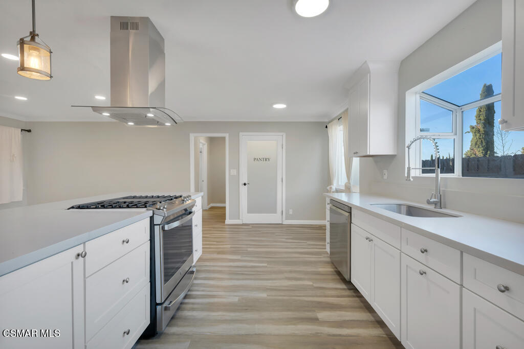 896 Moffatt Circle Simi Valley, CA 93065 - Photo 23 of 50 a large kitchen with granite countertop a stove and a sink