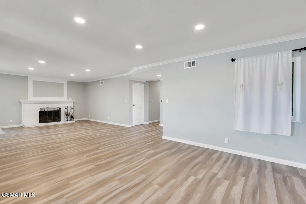 896 Moffatt Circle Simi Valley, CA 93065 - Photo 24 of 50 a view of empty room with wooden floor and fireplace