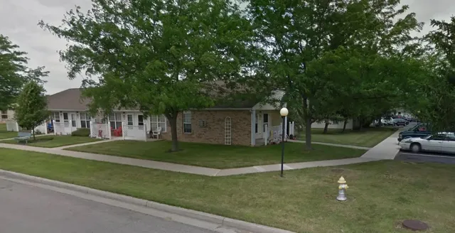 a backyard of a house with table and chairs