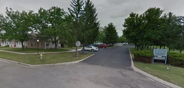 a view of a park with bench and trees