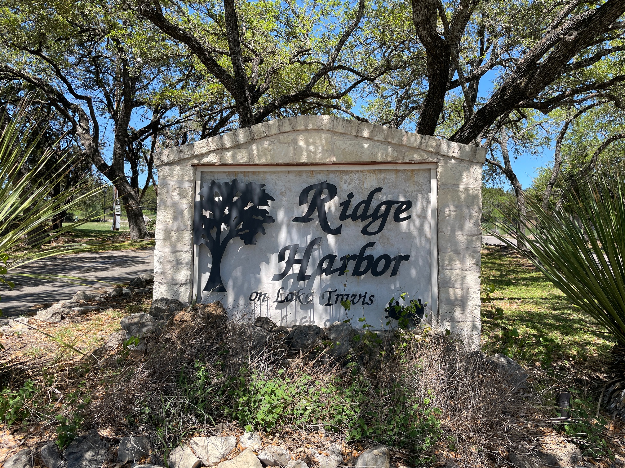 Lot 80 Wesley Ridge Drive Spicewood, TX 78669 - Photo 2 of 12 a sign on the side of a road