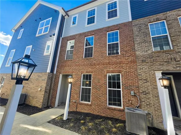 a front view of a building with a yard