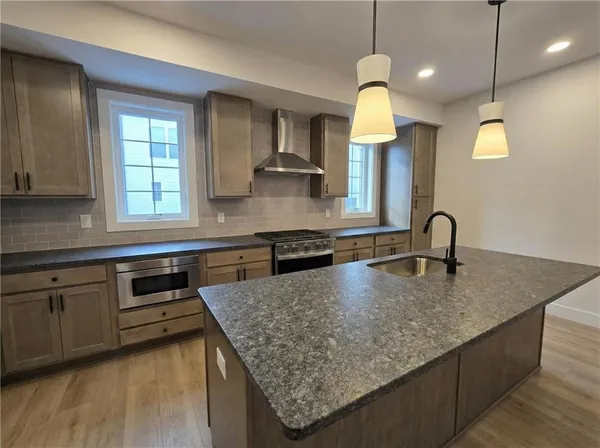 a view of kitchen and hall with wooden floor
