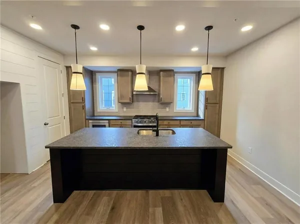 a view of kitchen and hall with wooden floor