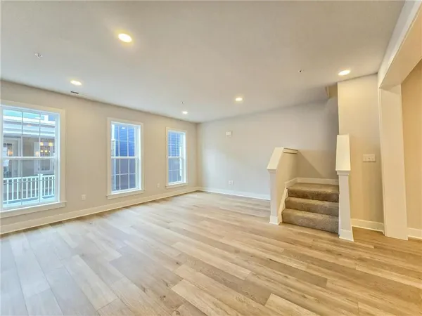 an empty room with closet and a bathroom