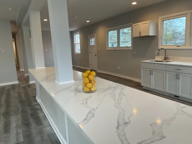 a view of a kitchen with sink and window