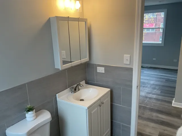 a view of a hallway with wooden floor and closet