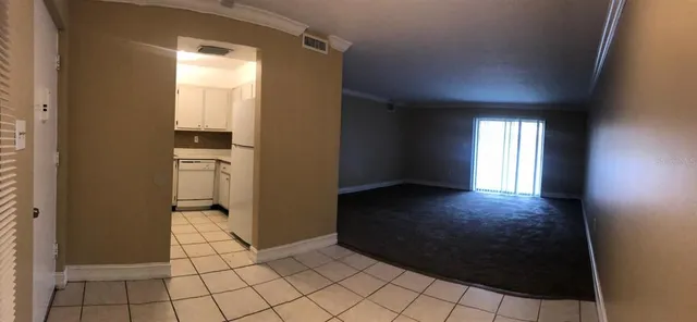 a view of a kitchen with stainless steel appliances granite countertop a sink and a stove