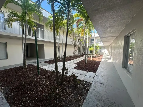 a view of a pathway with a backyard