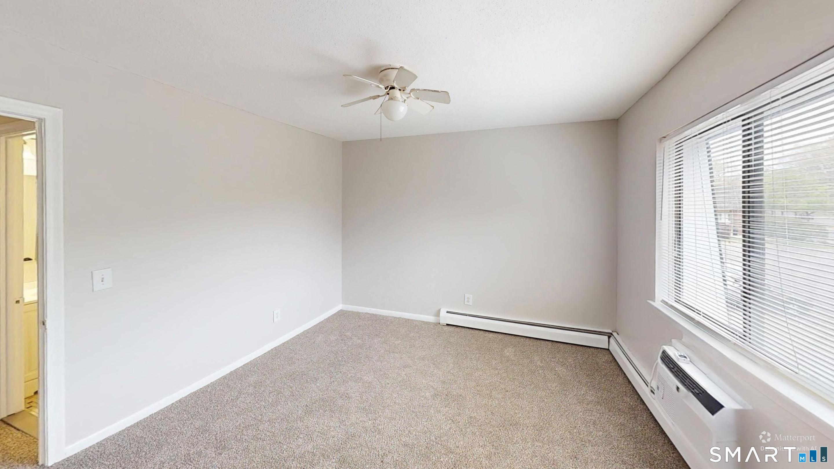 158 High Path Road, Unit 158 Windsor, CT 06095 - Photo 20 of 20 an empty room with a window and a ceiling fan
