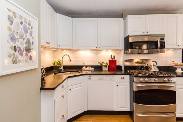 52 Aberdeen Road Arlington, MA 02476 - Photo 15 of 30 a kitchen with granite countertop white cabinets and stainless steel appliances