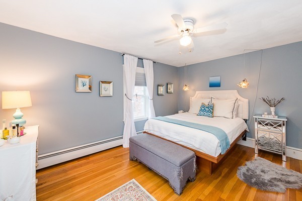 52 Aberdeen Road Arlington, MA 02476 - Photo 27 of 30 a bedroom with a bed and a chandelier