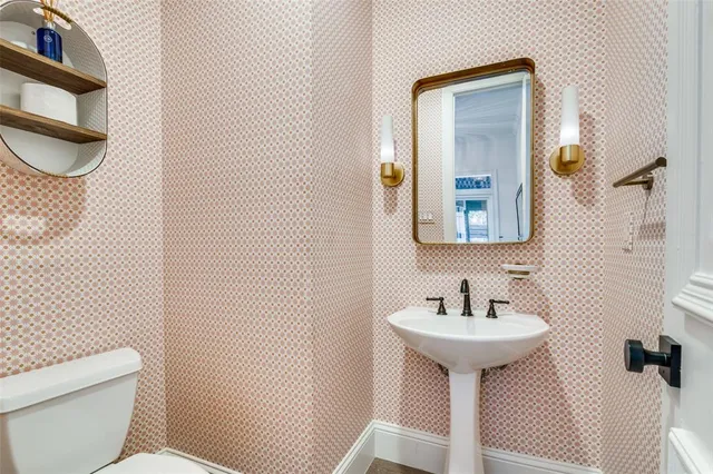 a bathroom with a sink toilet and mirror