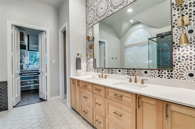 a bathroom with a double vanity sink and a mirror