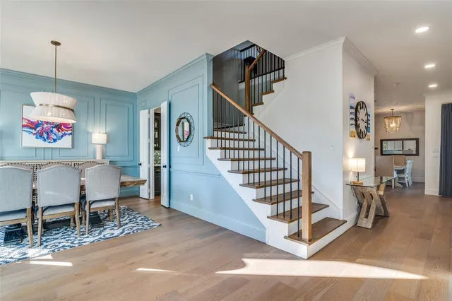 a view of a hallway with dining room and stairs