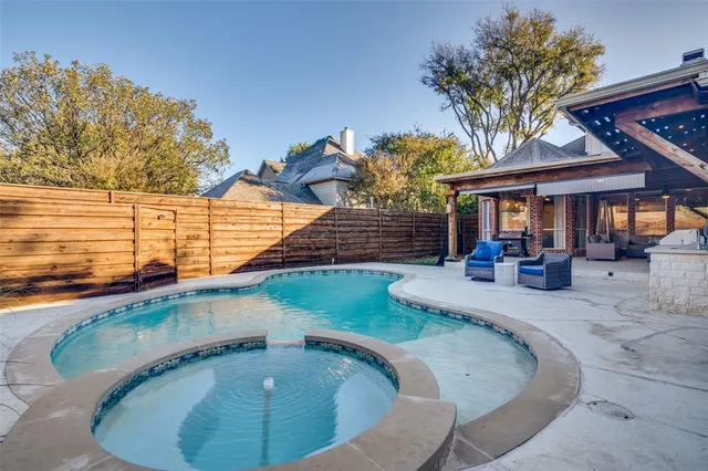 a swimming pool with outdoor seating outdoor seating and yard