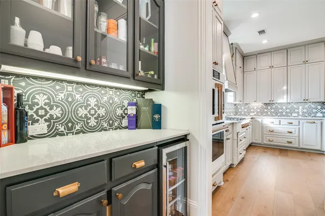 a kitchen with stainless steel appliances a stove a sink and a microwave