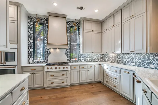 a kitchen with granite countertop white cabinets and white appliances