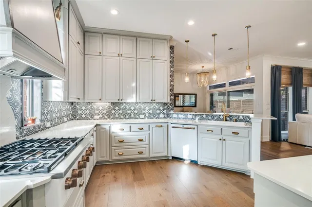a kitchen with stainless steel appliances granite countertop a stove and a sink