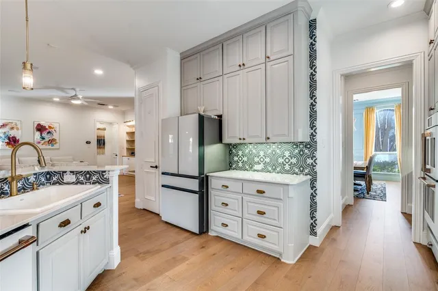a kitchen with white cabinets and stainless steel appliances