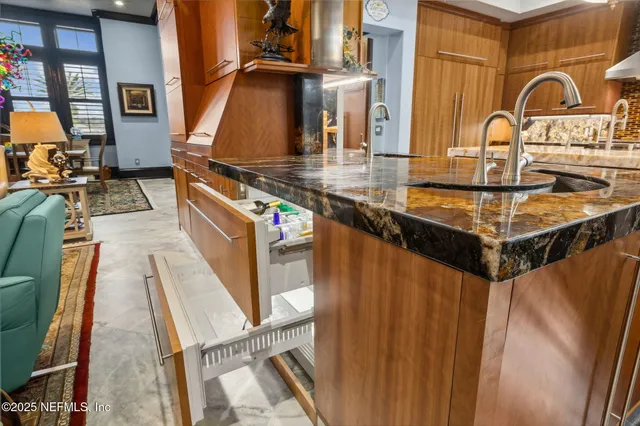 a spacious bedroom with a bed and a chandelier