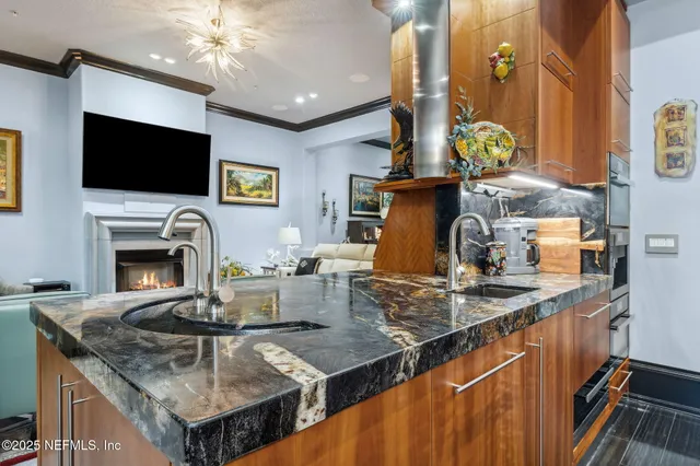 a bedroom with a bed a flat screen tv and a large window