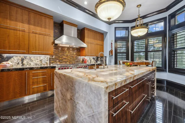a bathroom with a granite countertop sink a toilet and shower