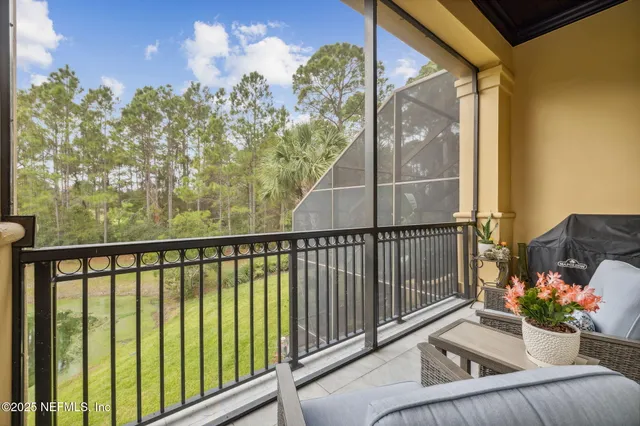 a view of a patio with table and chairs potted plants and palm tree