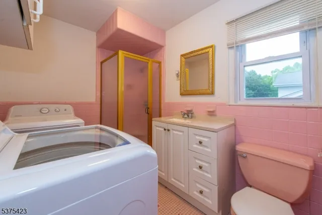 a spacious bathroom with a toilet sink and mirror