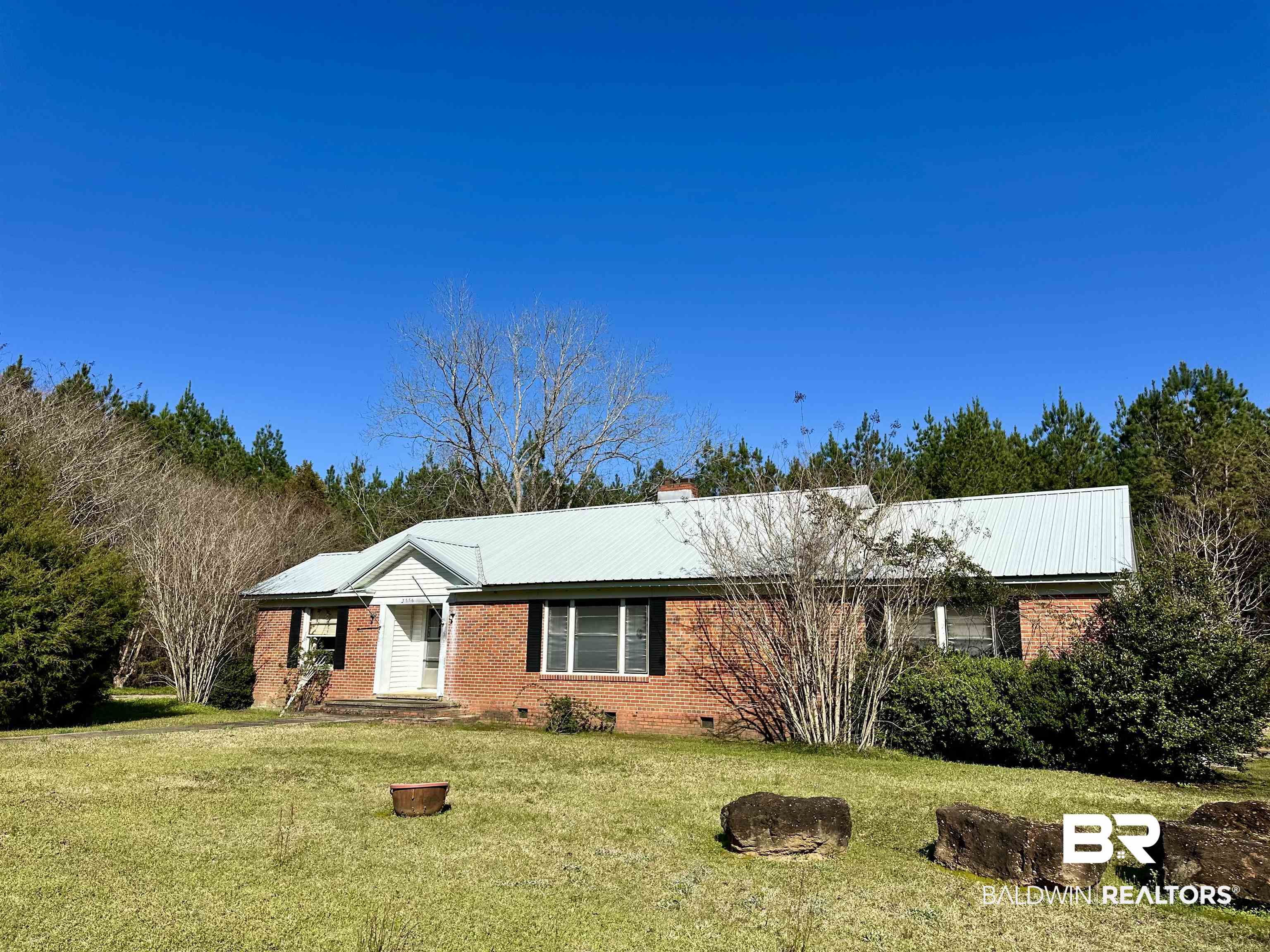 3556 Damascus Road Brewton, AL 36426 - Photo 1 of 17 Single story home with a front lawn, metal roof, a chimney, and crawl space