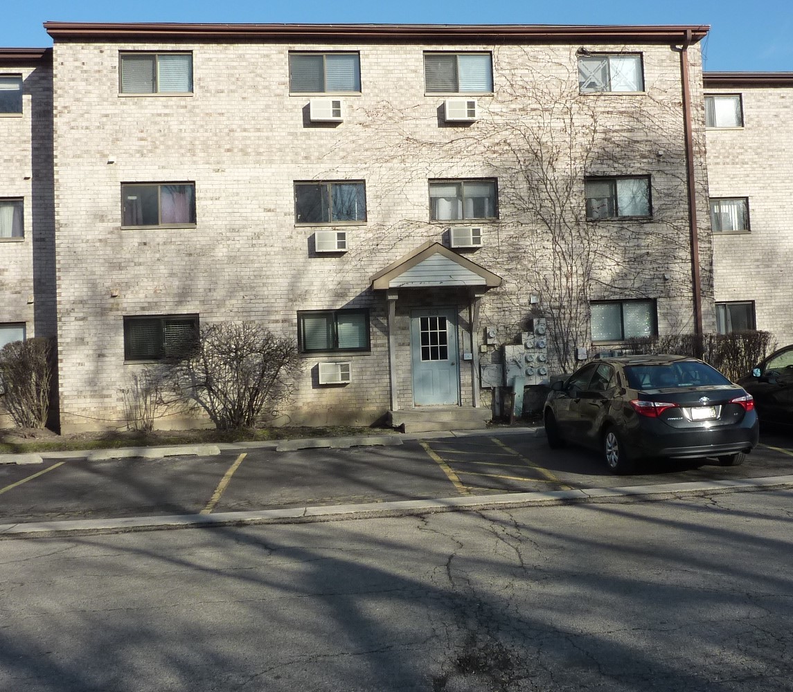 a view of a brick building next to a yard