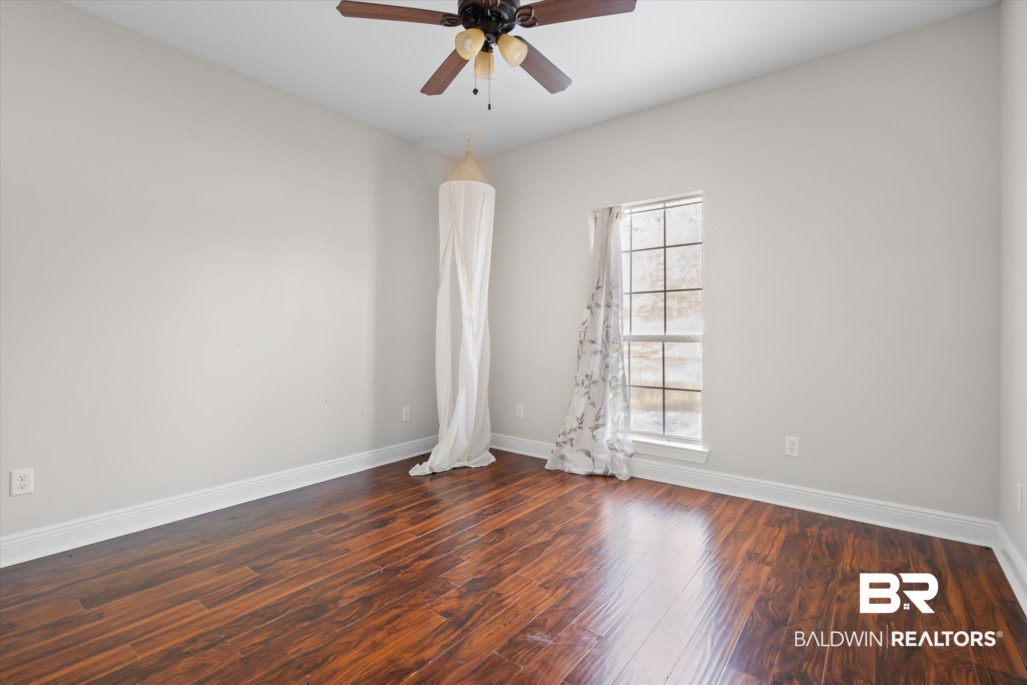20792 Lonnie Walker Road Citronelle, AL 36522 - Photo 8 of 19 Empty room featuring ceiling fan, plenty of natural light, and dark hardwood / wood-style floors
