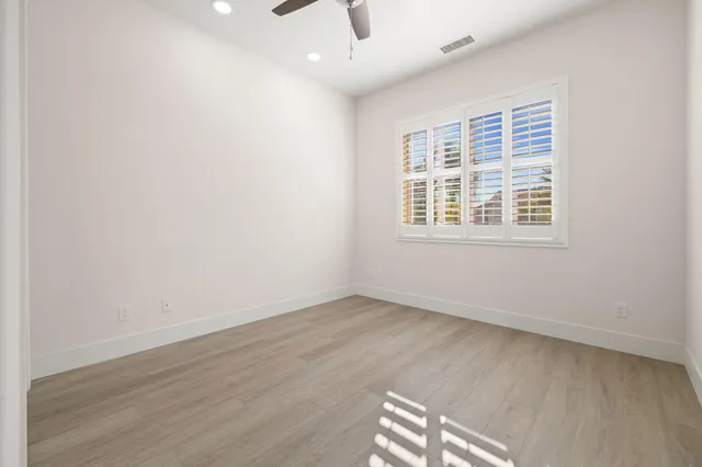 a bathroom with a sink a toilet a mirror and shower