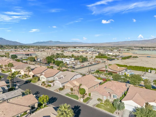 an aerial view of residential houses with outdoor space and river