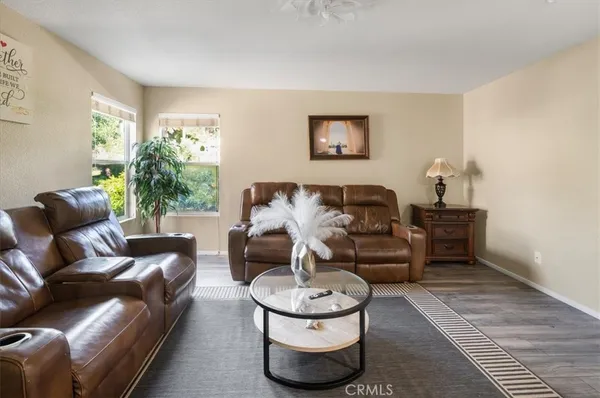 a living room with furniture and a potted plant
