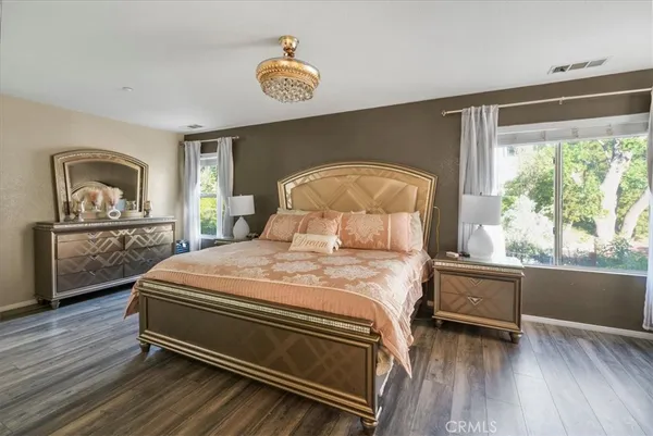 a bedroom with a bed and a large window