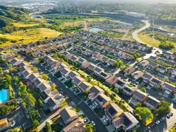 an aerial view of a house with a yard and lake view