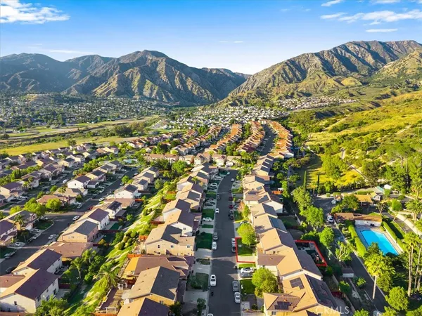 an aerial view of a residential houses with yard