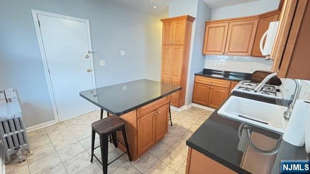 760 Hamilton Street, Unit 1 Harrison, NJ 07029 - Photo 16 of 23 a kitchen with stainless steel appliances granite countertop a sink a stove and a refrigerator