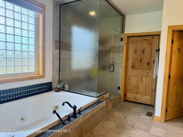 a bathroom with a tub and a shower