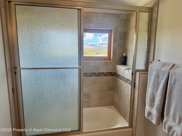 a bathroom with a glass shower door