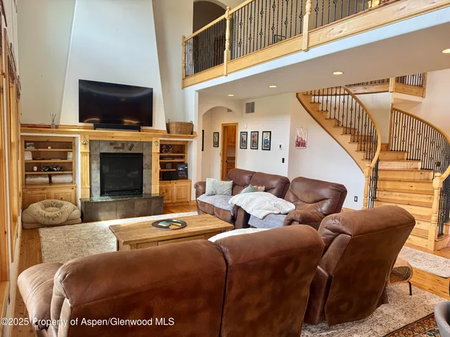 a living room with fireplace furniture and a flat screen tv