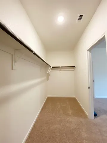 a view of a hallway with wooden floor and a fireplace