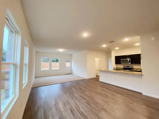 a kitchen with stainless steel appliances wooden cabinets and granite counter tops