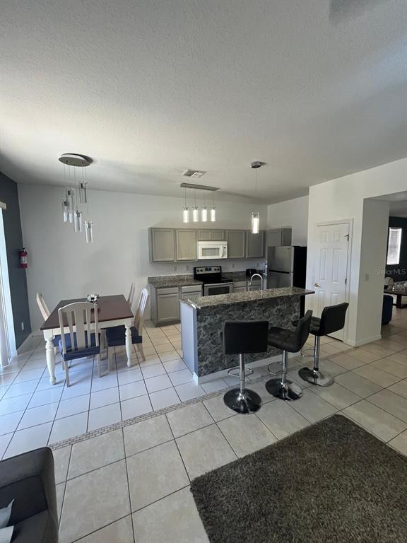 435 Kettering Road Davenport, FL 33897 - Photo 6 of 8 a kitchen with a dining table chairs and view kitchen
