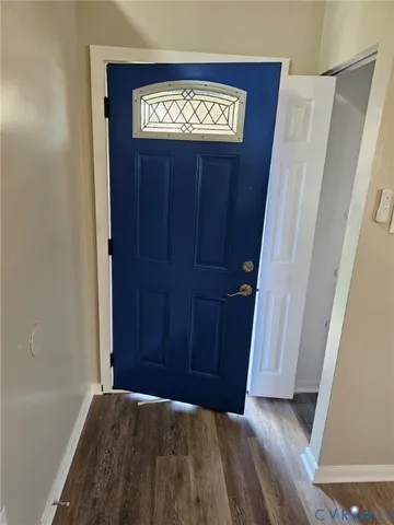a view of front door with a door and stairs