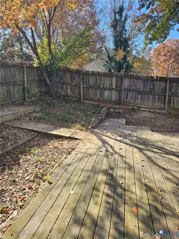 a view of yard with wooden fence