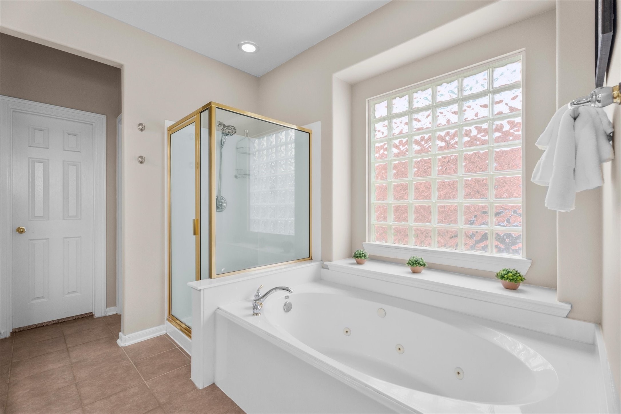 6323 Stone Trail Lane Spring, TX 77379 - Photo 20 of 43 a bathroom with a bathtub a shower and a window