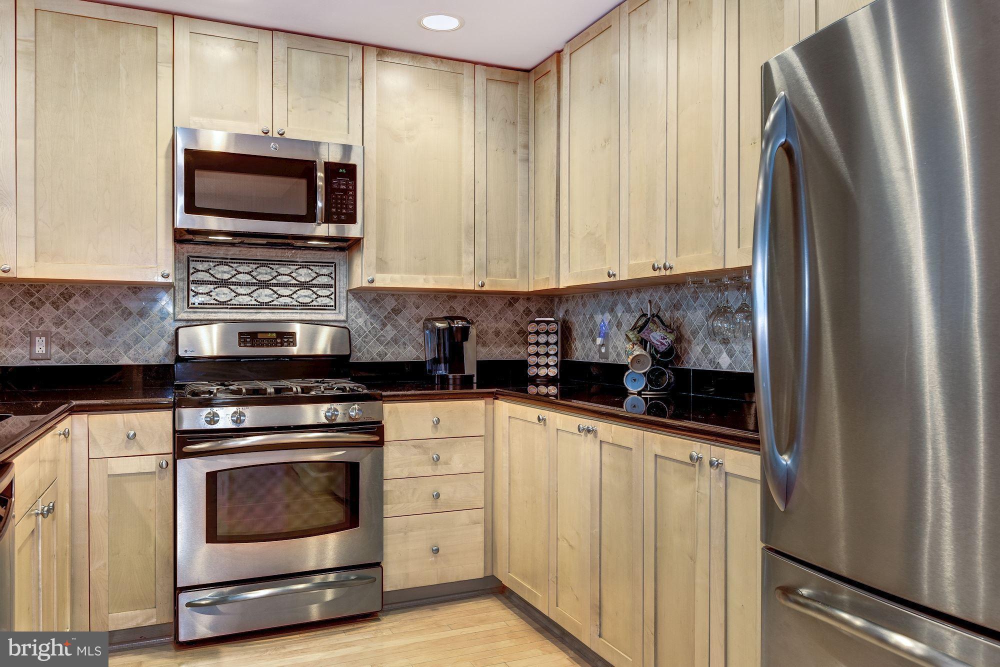 3600 South Glebe Road, Unit 918W Arlington, VA 22202 - Photo 2 of 30 a kitchen with stainless steel appliances a stove a microwave and sink